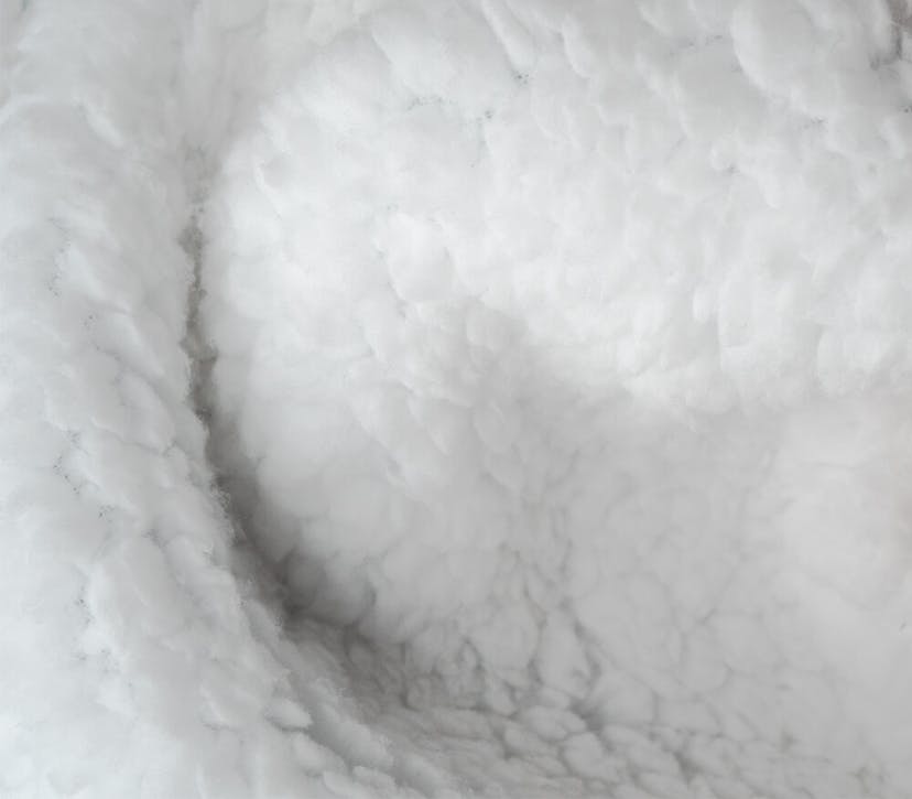  Behold, a close-up of a white cloud that resembles the softness and texture of woolen hoodie material. Pure tranquility!